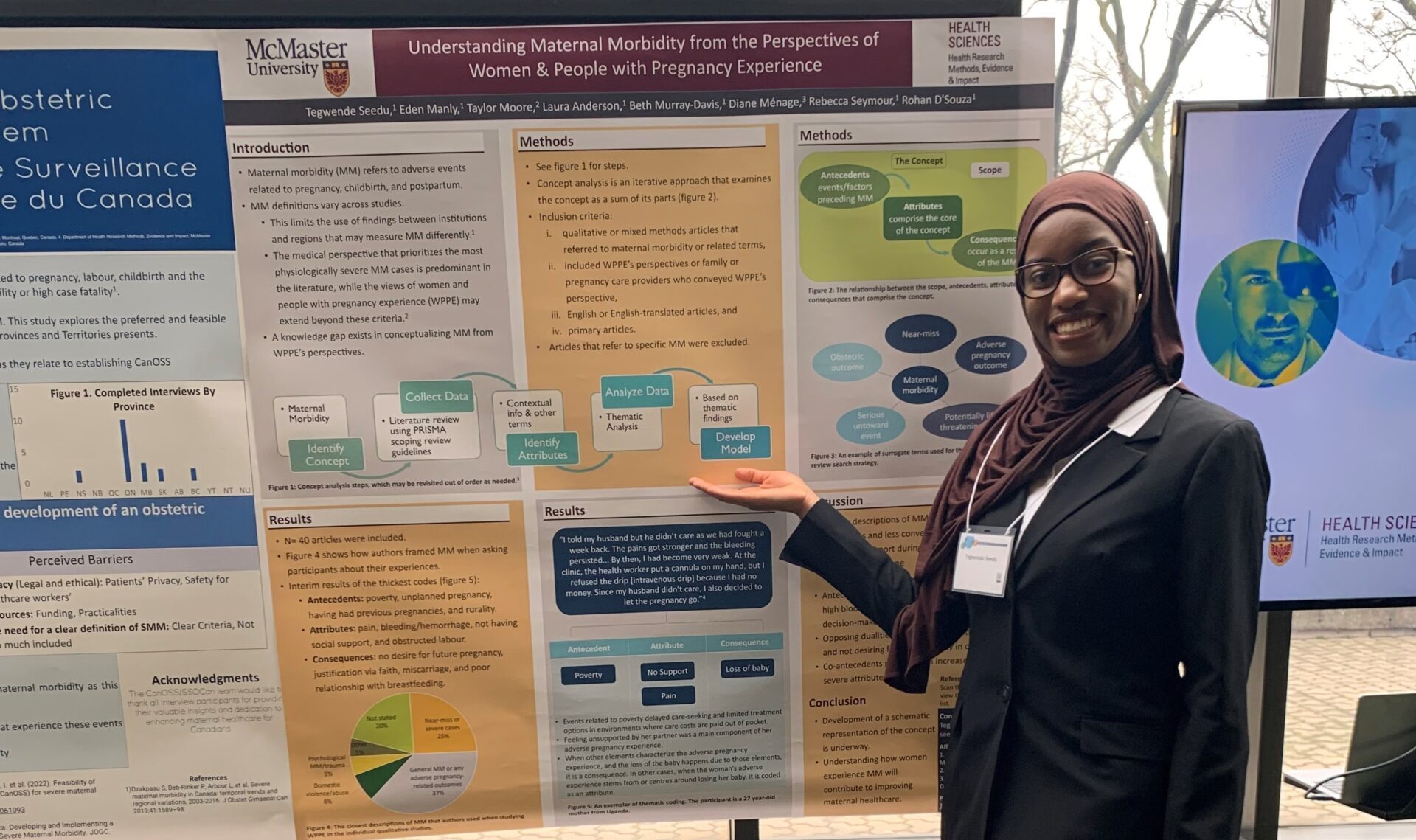 Tegwende Seedu stands next to her research poster. 