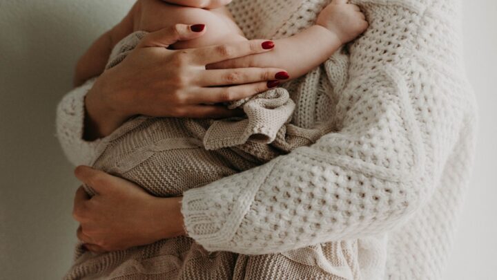 Parent holding a baby.