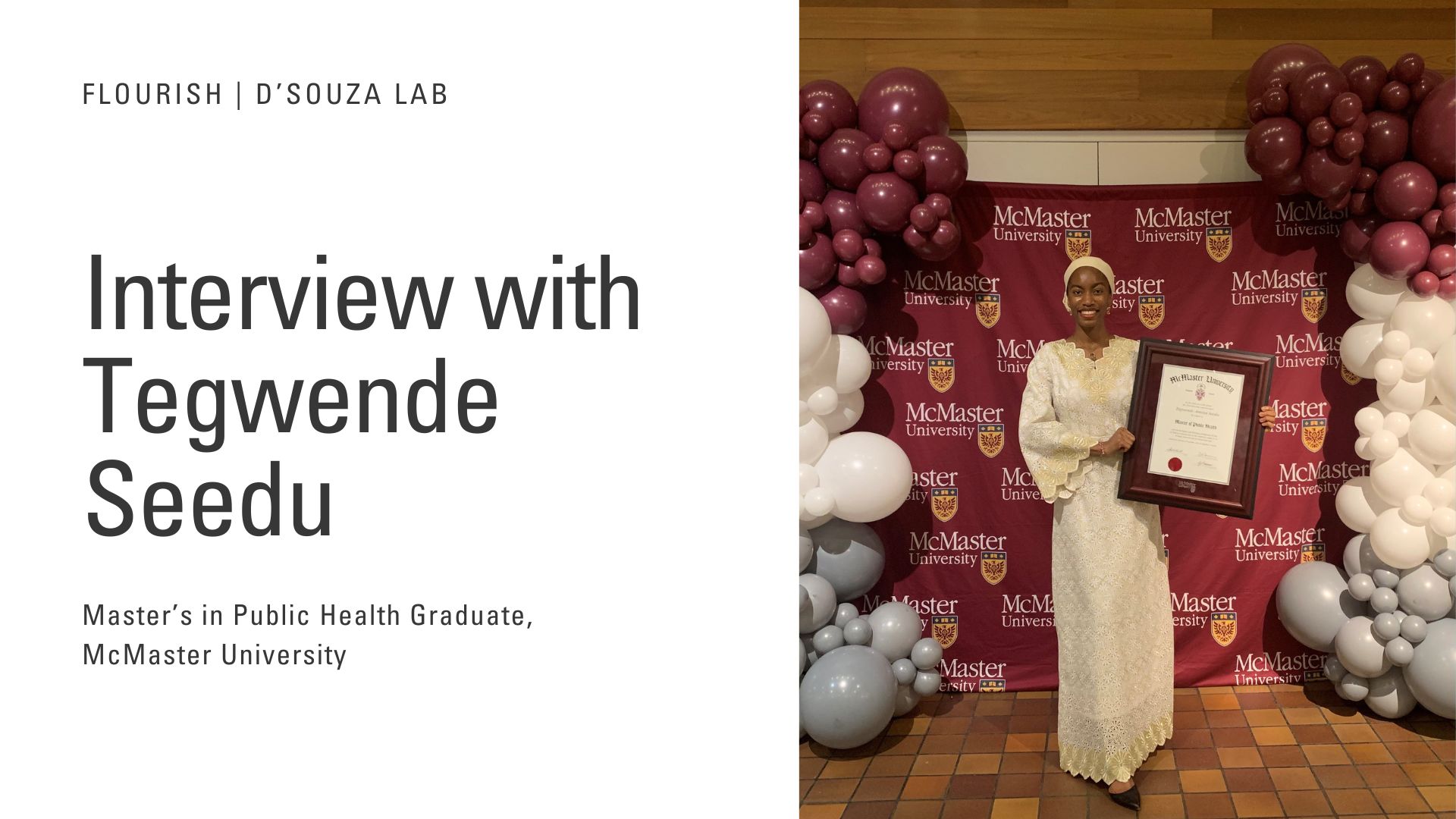 Tegwende holding her diploma next to a McMaster banner and balloons.